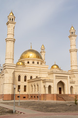 Fototapeta na wymiar Petropavlovsk, Kazakhstan - May 6, 2019: Muslim mosque, golden domes.