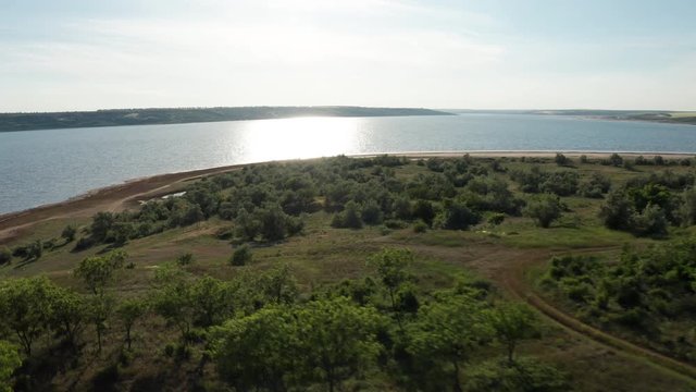 Aerial view of natural lake at sunset drone footage