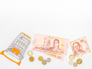 Business concept. Thai banknotes in shopping trolley isolated on white background.
