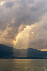 Naklejka na ściany i meble Sunlight through the clouds at dawn, island Koh Samui, Thailand