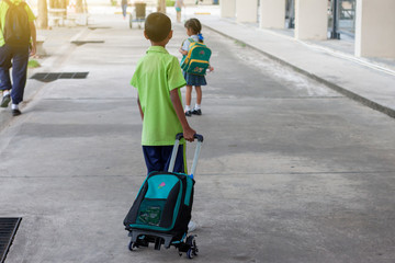 The student use drag bags due to carrying a heavy bag may cause the back to bend.