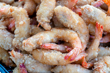Fried shrimp deep-fried is a street food in local market in Thailand, closeup. Thai food