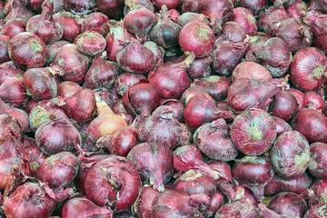 Red onions for sale at a market