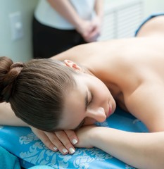 Obraz na płótnie Canvas Spa massage. Young girl lying on her stomach