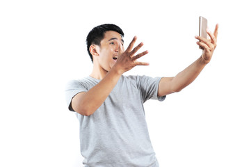 Excited expression on front of a smartphone. Portrait of happy asian person very excited when get the best price at online store