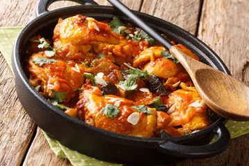 Spicy pieces of Chicken with eggplant, almonds with vegetable gravy close-up in a pan. horizontal