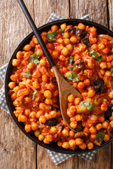 Traditional Middle Eastern Druze recipe of stew of chickpeas with eggplant closeup on a plate. Vertical top view