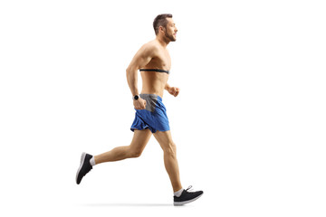 Fototapeta premium Fit guy jogging and wearing a chest strap monitor