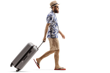 Bearded man with a suitcase walking