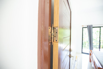 Brown teak door with stainless knob in contemporary house