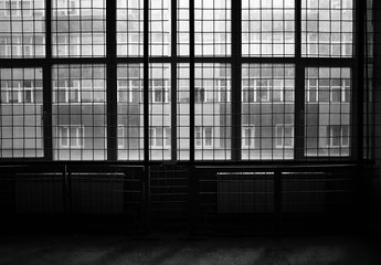 Empty industrial workshop with caged windows background
