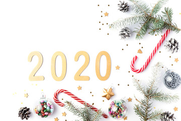 Christmas frame made of fir branches, cones, gold stars and decorations. Christmas wallpaper. 2020 background isolated on white. Flat lay, top view, copy space