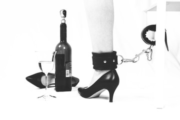 Chained Leg and wine. BDSM concept. Domination.
