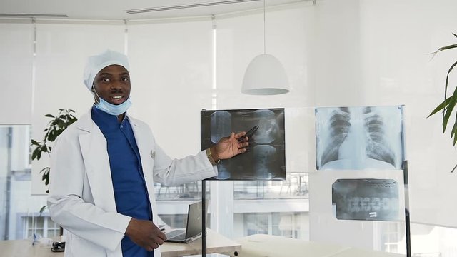 Male doctor examining x-ray of a patien in the hospital.