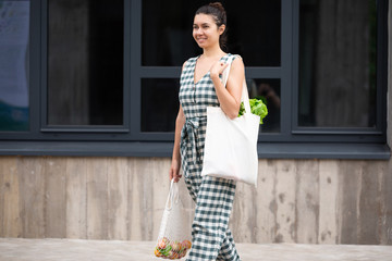 Young woman with white cotton Eco bag in hands. Lifestyle, zero waste concept