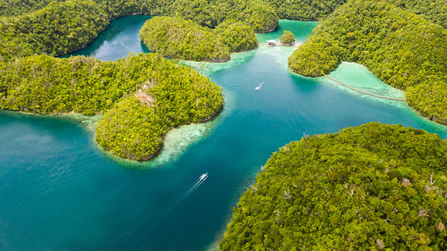 Cove and blue lagoon among small islands covered with rainforest. Sugba lagoon, Siargao, Philippines. Aerial view of Sugba lagoon, Siargao,Philippines.