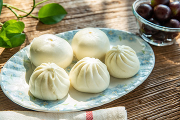 Fototapeta premium The morning sun shines on the nutritious breakfast on the wooden table.