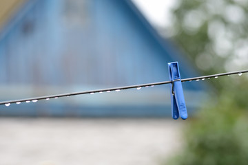 Plastic clothesline with water drops after rain close up