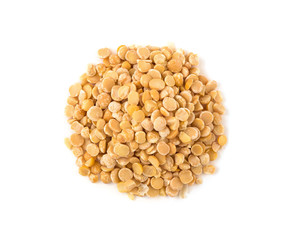 Top view of yellow split pea seeds. Raw food isolated on white background