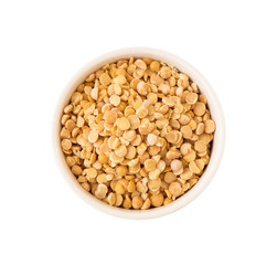 Top view of yellow pea seeds in round ceramic plate isolated on white background