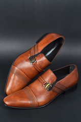 Tan brown Victorian men shoes on black ground