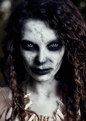 Halloween theme: creepy grim voodoo witch. Close-up portrait of evil sorceress. Zombie woman...