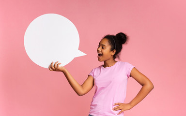 African American girl making announcement at white blank speech bubble