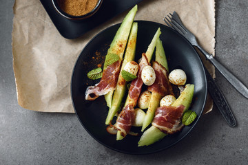 Melon salad with prosciutto and cheese..