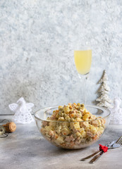 Traditional Russian New Year and Christmas salad of vegetables, meat and mayonnaise called Olivier. Russian salad. Selective focus. Vertical. Light background. Copyspace