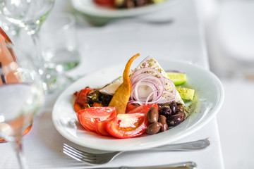 Salad made of tomatoes, cucumbers, feta chees and black olives in a restaurant