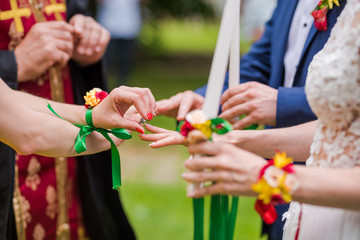 Christian wedding ceremony. Bide and groom getting their wedding rings crossed by the maid of honour.