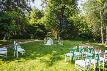 Wedding arch made of red and yellow flowers 