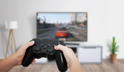 Boy play game on large TV in living room. Concept of digital entertainment, gaming industry. © Stanisic Vladimir