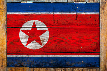 National flag of North Korea on a wooden wall background.The concept of national pride and symbol...