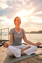 Fototapeta na wymiar Female on dock in yoga pose