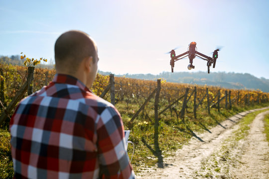 Man filming vineyard with drone