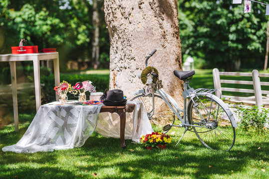 Wedding decoration with a decorative bicycle and photo corner with signs and accessoires for photos. Garden wedding decoration.