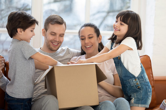 Happy family with kids customers open cardboard box at home
