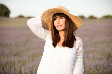Pretty woman in lavender flowers field