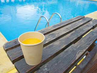 Fototapeta na wymiar Orange juice in the pool
