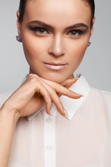 Portrait of a beautiful pacified woman in a white shirt. Studio photo session