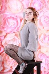 Girl with blond hair and gray sweater