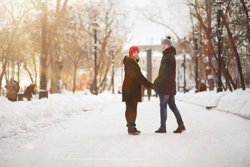 Fototapeta na wymiar Young couple walking through the winter