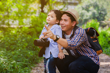 Father and son walk in the forest