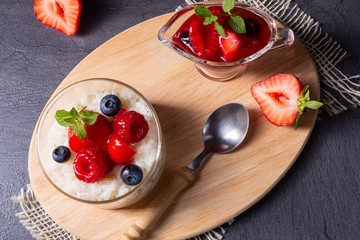 delicious milk rice with different berries and red fruit jelly