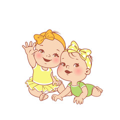 Little baby girls siting, lying on the stomach. Twins, girl and girl together.