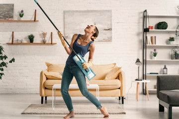 Merry woman playing with swab during cleaning