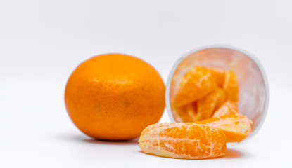 Orange fruit in the glass and White background