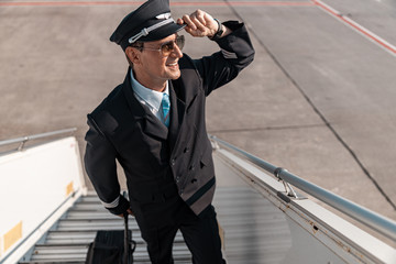 Caucasian smiling man in sunglasses looking at somebody