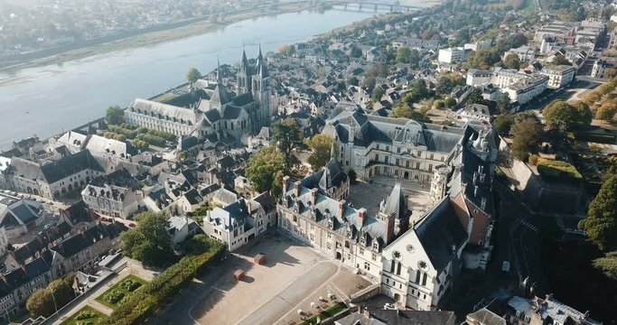 View from drone of impressive Royal Chateau de Blois on background with cityscape in sunny autumn day, France